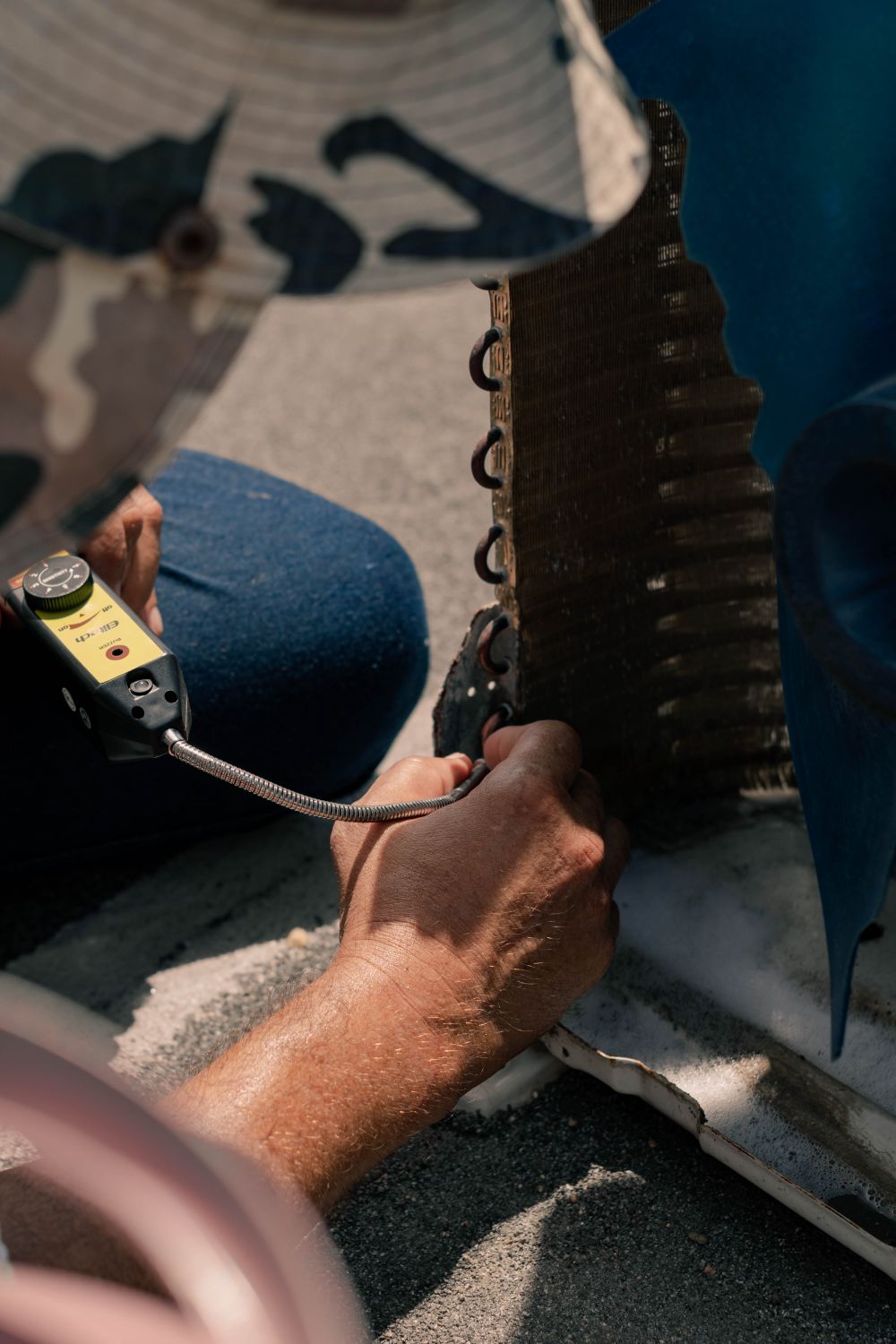 Technician servicing an outdoor air conditioning unit